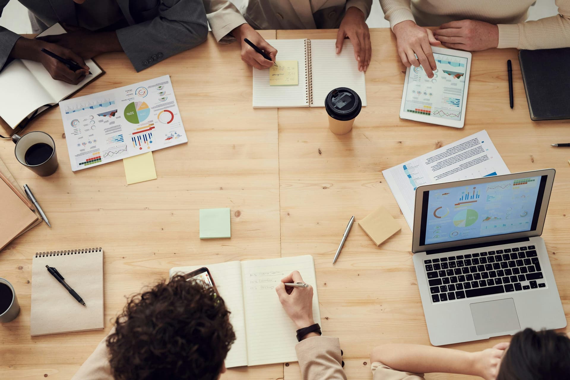 Group of people working at a table on computers