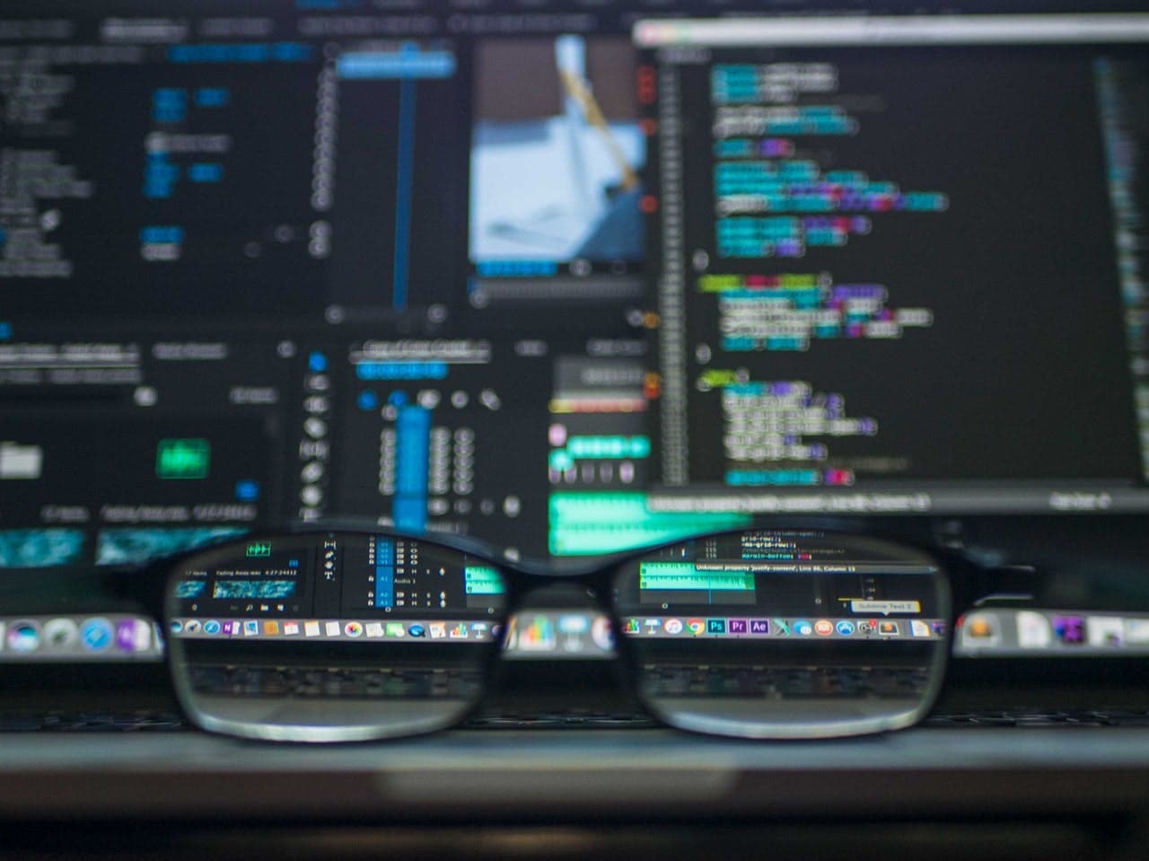 an eyeglass in front of a computer screen